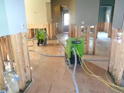 Dehumidifier running in a Menifee hallway with drywall cut away to the studs